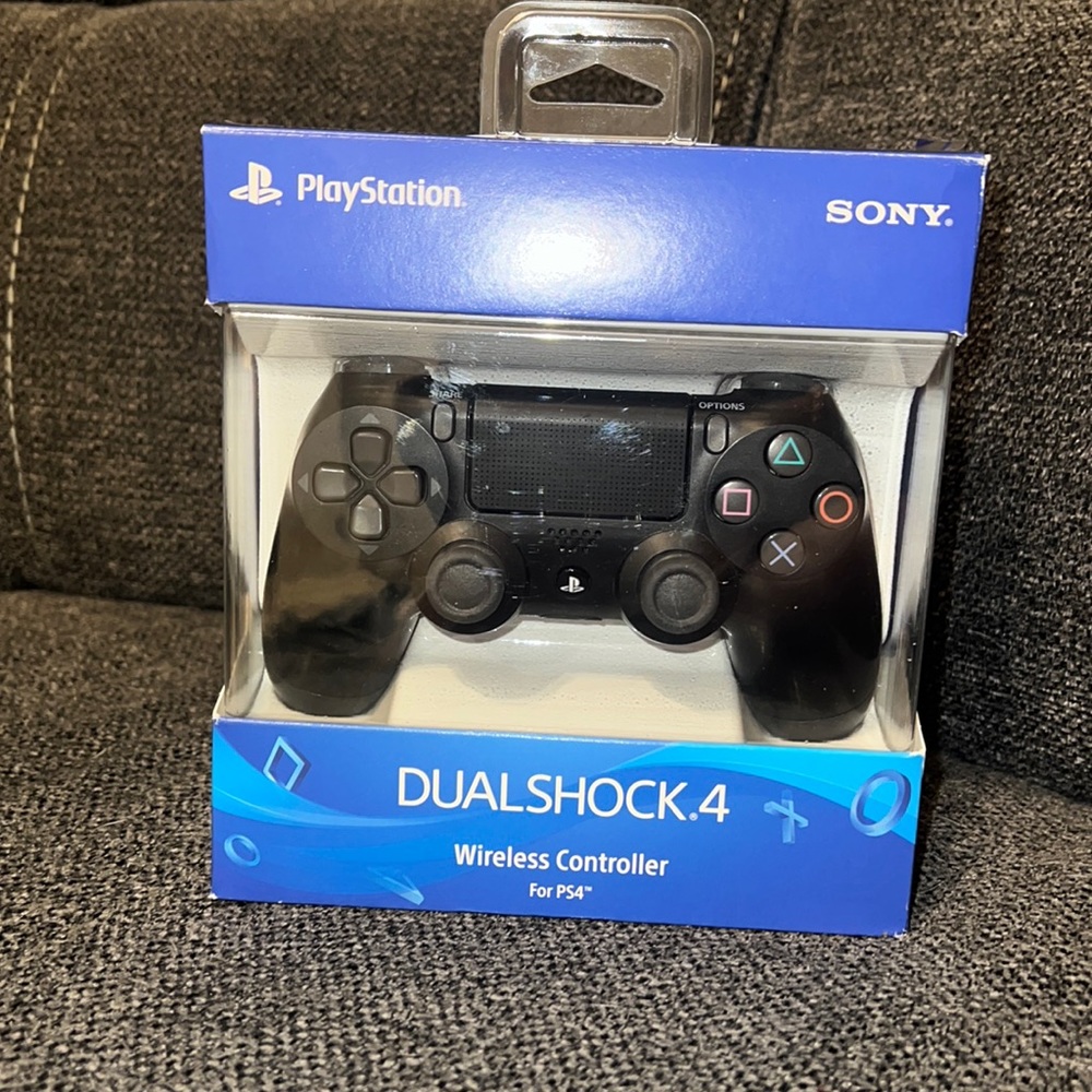 Black Sony PlayStation dual shock wireless remote.
